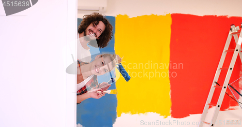 Image of portrait of a couple painting interior wall