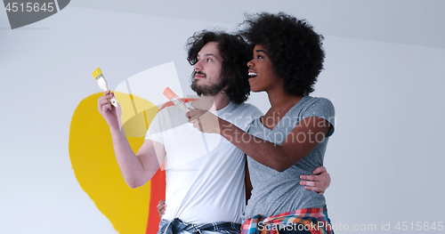 Image of couple with painted heart on wall