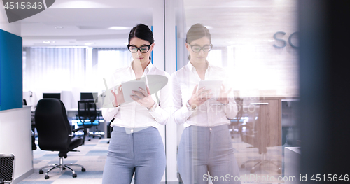 Image of Business Woman Using Digital Tablet in front of Office