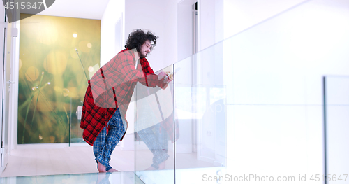 Image of young man using a tablet at home