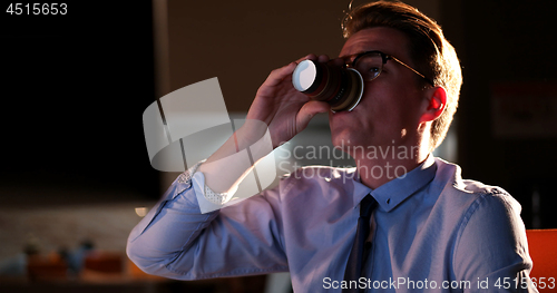 Image of Tired businessman working late