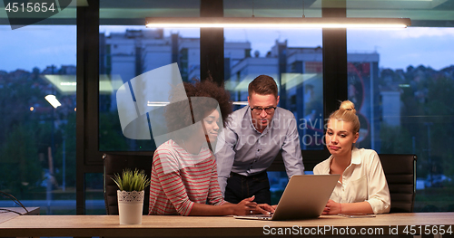 Image of Multiethnic startup business team in night office