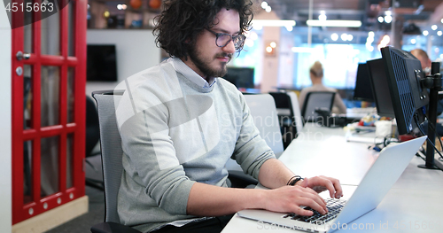 Image of businessman working using a laptop in startup office