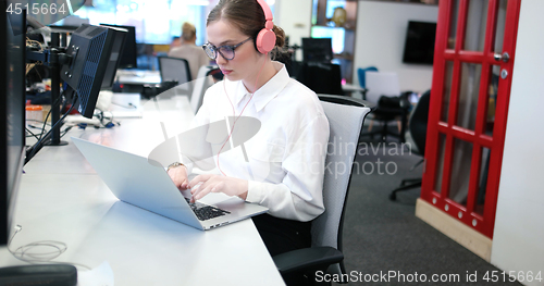 Image of businesswoman using a laptop in startup office