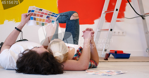 Image of Happy young couple relaxing after painting