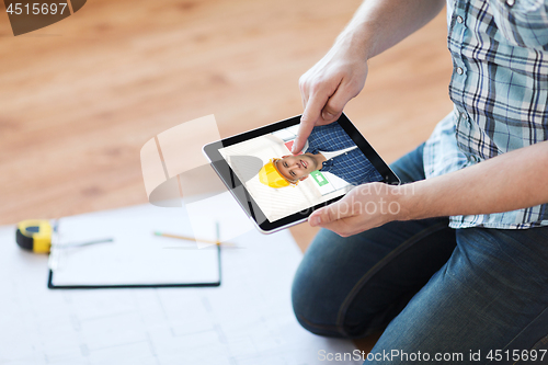 Image of man having video call with builder on tablet pc