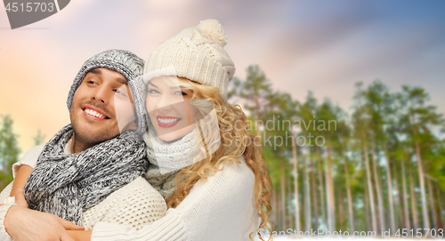 Image of couple hugging over winter forest background