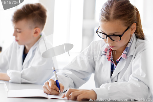 Image of close up of girl studying chemistry at school