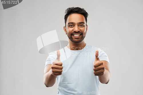 Image of happy indian man in t-shirt showing thumbs up