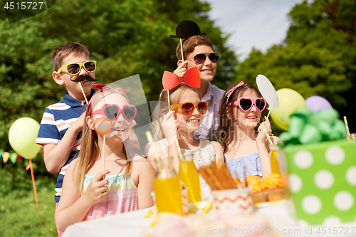 Image of happy kids with party props on birthday in summer