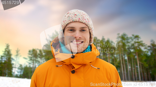 Image of happy young man in winter clothes outdoors