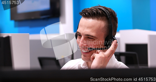 Image of male call centre operator doing his job