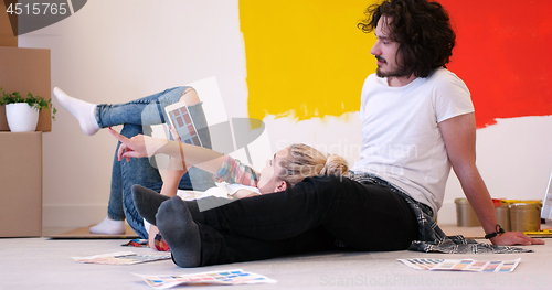 Image of Happy young couple relaxing after painting