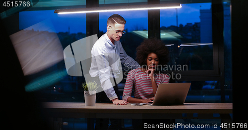 Image of Multiethnic startup business team in night office