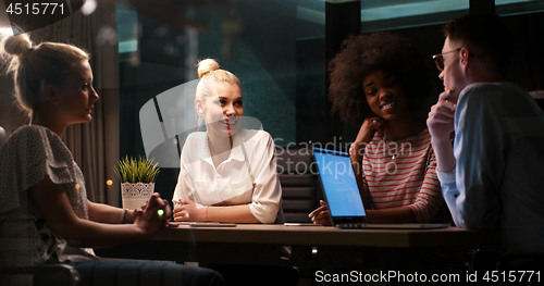 Image of Multiethnic startup business team in night office