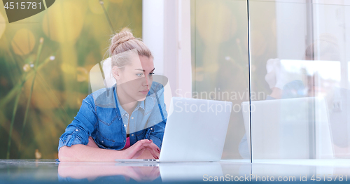 Image of young women using laptop computer on the floor