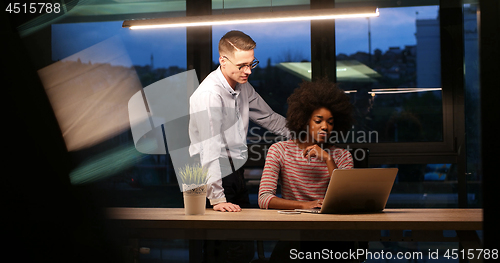 Image of Multiethnic startup business team in night office