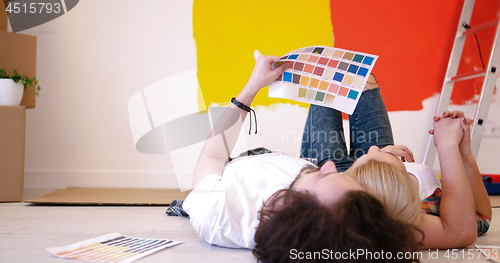 Image of Happy young couple relaxing after painting