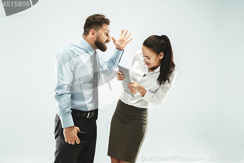 Image of a business man shows the laptop to his colleague in the office.