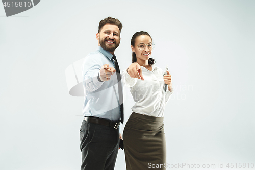 Image of a business man shows the laptop to his colleague in the office.