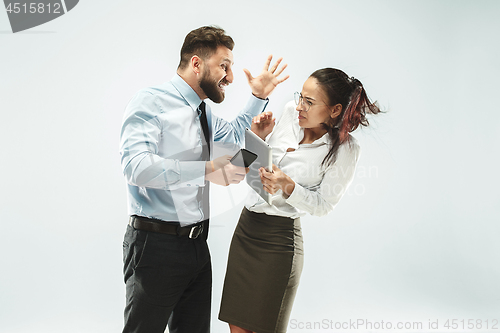 Image of angry businessman and his colleague in the office.