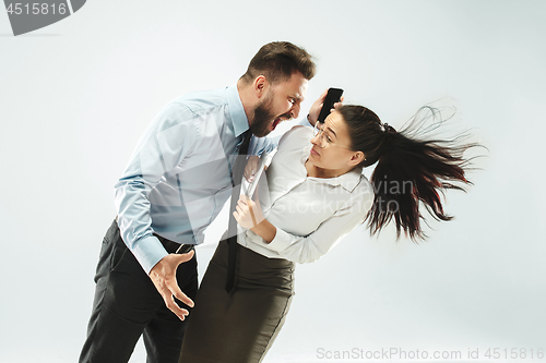 Image of angry businessman and his colleague in the office.