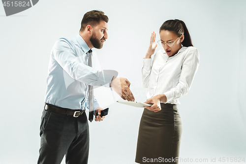 Image of a business man shows the laptop to his colleague in the office.