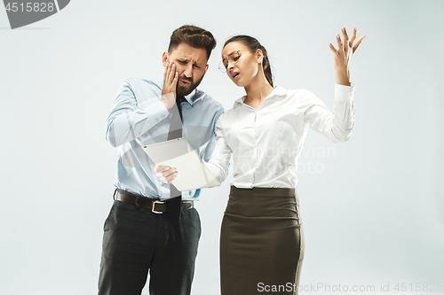 Image of a business man shows the laptop to his colleague in the office.