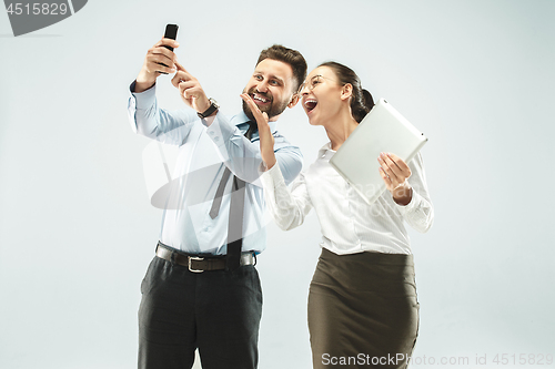 Image of a business man shows the laptop to his colleague in the office.