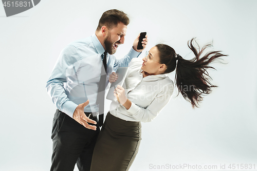 Image of angry businessman and his colleague in the office.