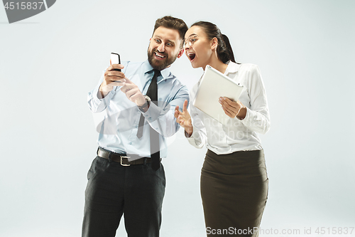 Image of a business man shows the laptop to his colleague in the office.