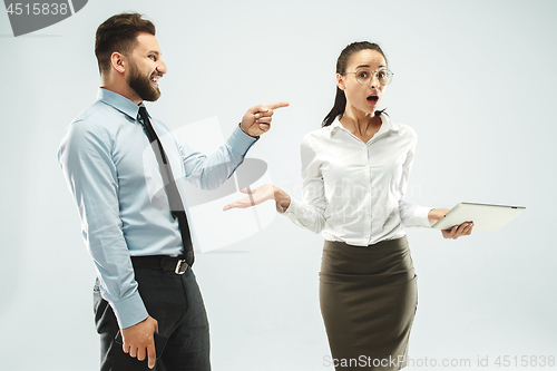 Image of a business man shows the laptop to his colleague in the office.