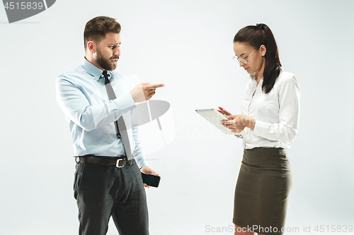 Image of a business man shows the laptop to his colleague in the office.