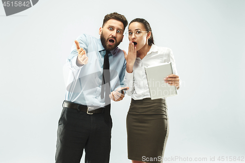 Image of a business man shows the laptop to his colleague in the office.