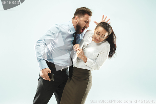 Image of angry businessman and his colleague in the office.