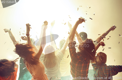 Image of Nightlife and disco concept. Young people are dancing in club.