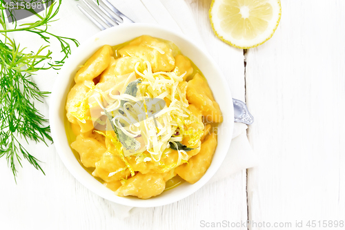 Image of Gnocchi pumpkin with lemon in bowl on light board top