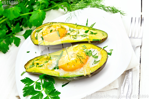 Image of Scrambled eggs in avocado on white board