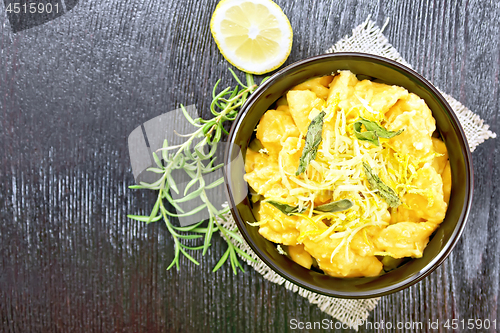 Image of Gnocchi pumpkin with lemon in bowl on dark board top