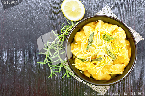 Image of Gnocchi pumpkin with lemon in bowl on dark board top