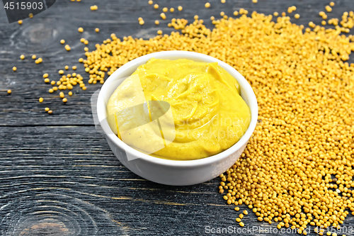 Image of Sauce mustard in bowl with seeds on board