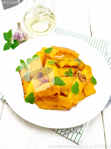 Image of Pumpkin with garlic and mint in plate on board