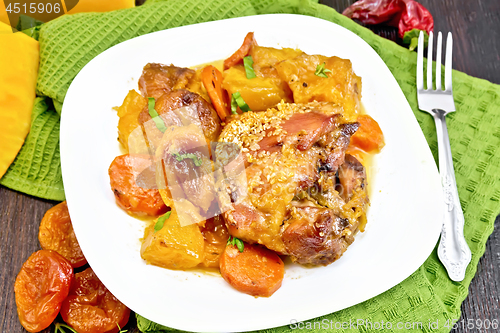 Image of Chicken roast with pumpkin and carrots on green towel