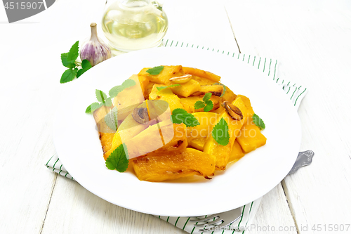 Image of Pumpkin with garlic and mint in plate on light board