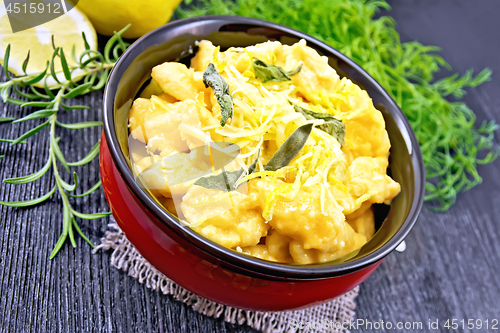 Image of Gnocchi pumpkin with lemon in bowl on dark board