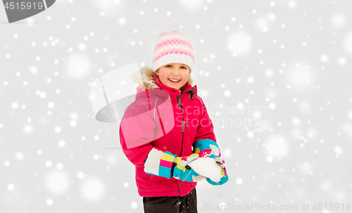 Image of happy little girl playing with snow in winter