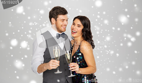 Image of happy couple with champagne celebrating christmas