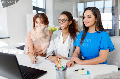 Image of businesswomen with laptop working at office