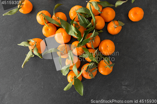 Image of close up of mandarins on slate table top