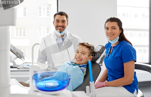 Image of dentists and kid patient at dental clinic